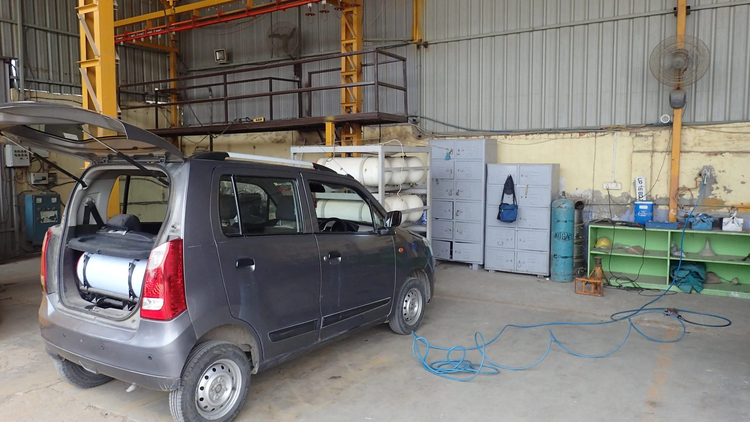 A CNG cylinder being removed from a car for testing